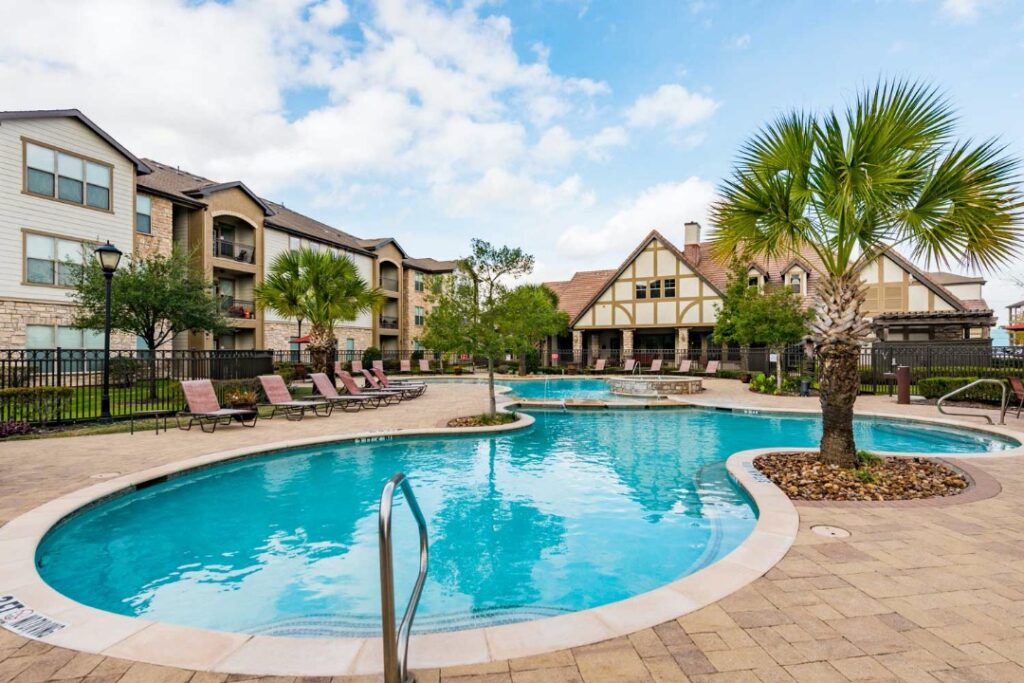 Swimming pool and apartment exterior at Kensington Crossing