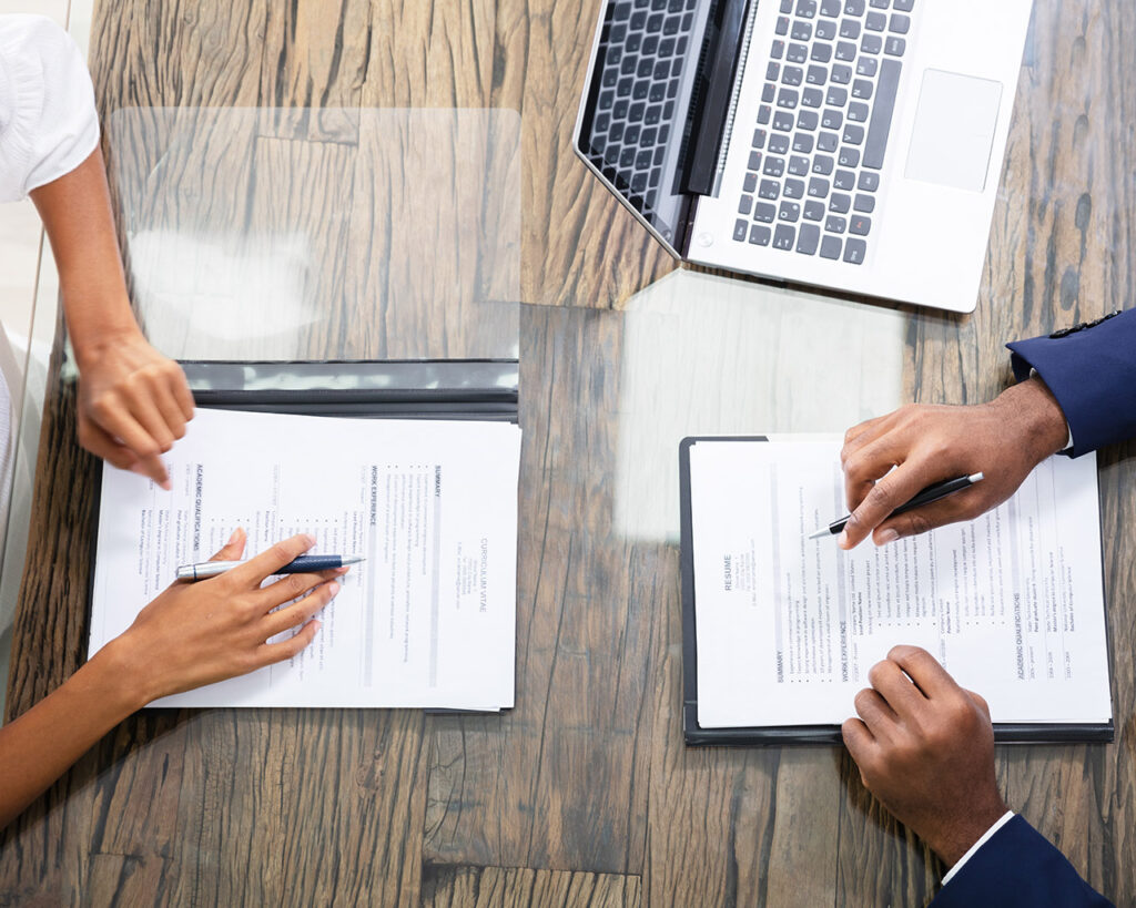 Two people holding documents